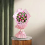 8 Pink Roses Bouquet wrapped in pastel pink paper with baby's breath, ideal for graceful gifting. Order now for same-day delivery.
