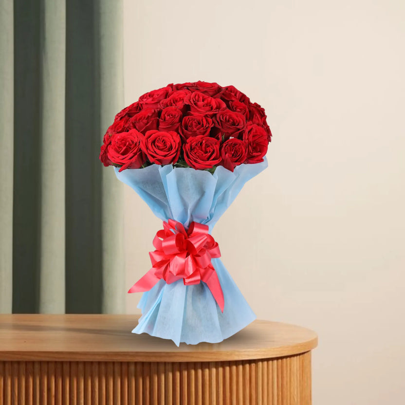 Classic Aura 12 Red Roses Bouquet - Perfect Gift featuring vibrant red roses wrapped in blue paper with a red ribbon, ideal for anniversaries. Main image