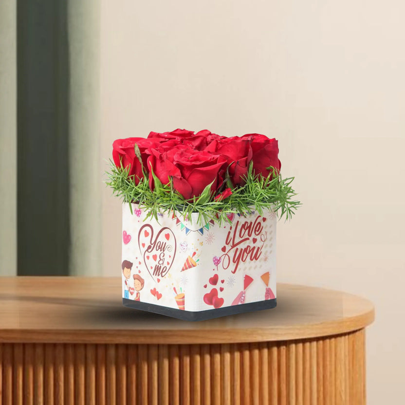 Red Roses Sticker Vase - You And Me displayed on a wooden table, featuring 9 fresh red roses in a romantic printed glass vase, ideal for anniversaries. Main image