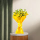 Asiatic Lilies Bunch - Lovely Flowers in bright yellow wrapping, displayed on a marble-top stand. Perfect for anniversaries or same day delivery.