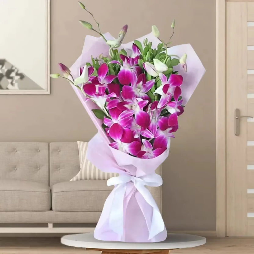Heart Winning Orchids Bouquet with vibrant purple and white orchids wrapped in pastel paper, ideal for anniversaries and elegant gifting. Main image