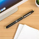 Kross Roller Gold Pen - Gold Metal Roller Pen placed on office desk near computer and papers, ideal for stylish professional writing.