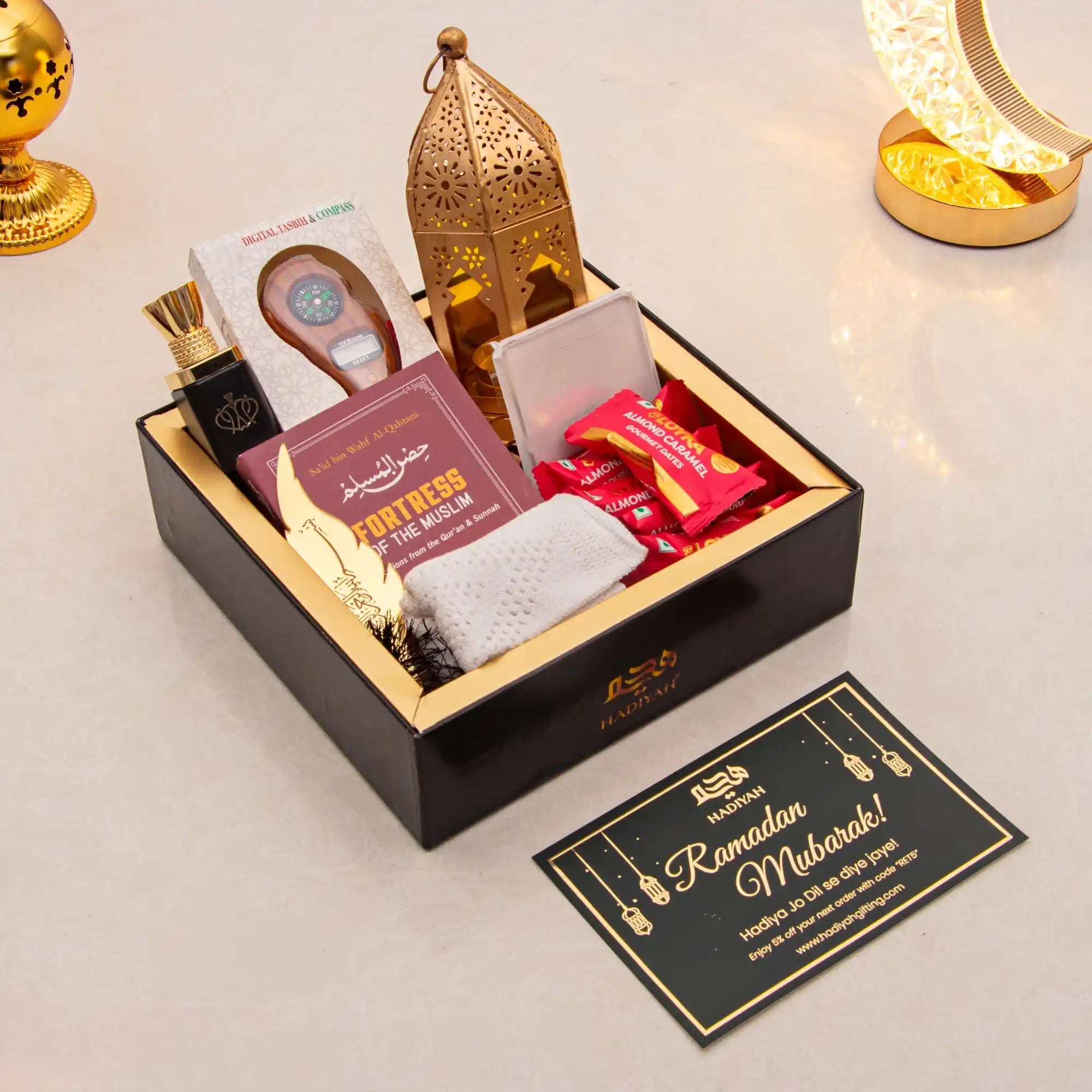 Gift box with Ramadan-themed items on a light background Main image