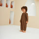 Smiling toddler in Brown Thobe Romper Boys - Baby Boys Thobe Romper, designed for comfort and style during Ramadan or special occasions.