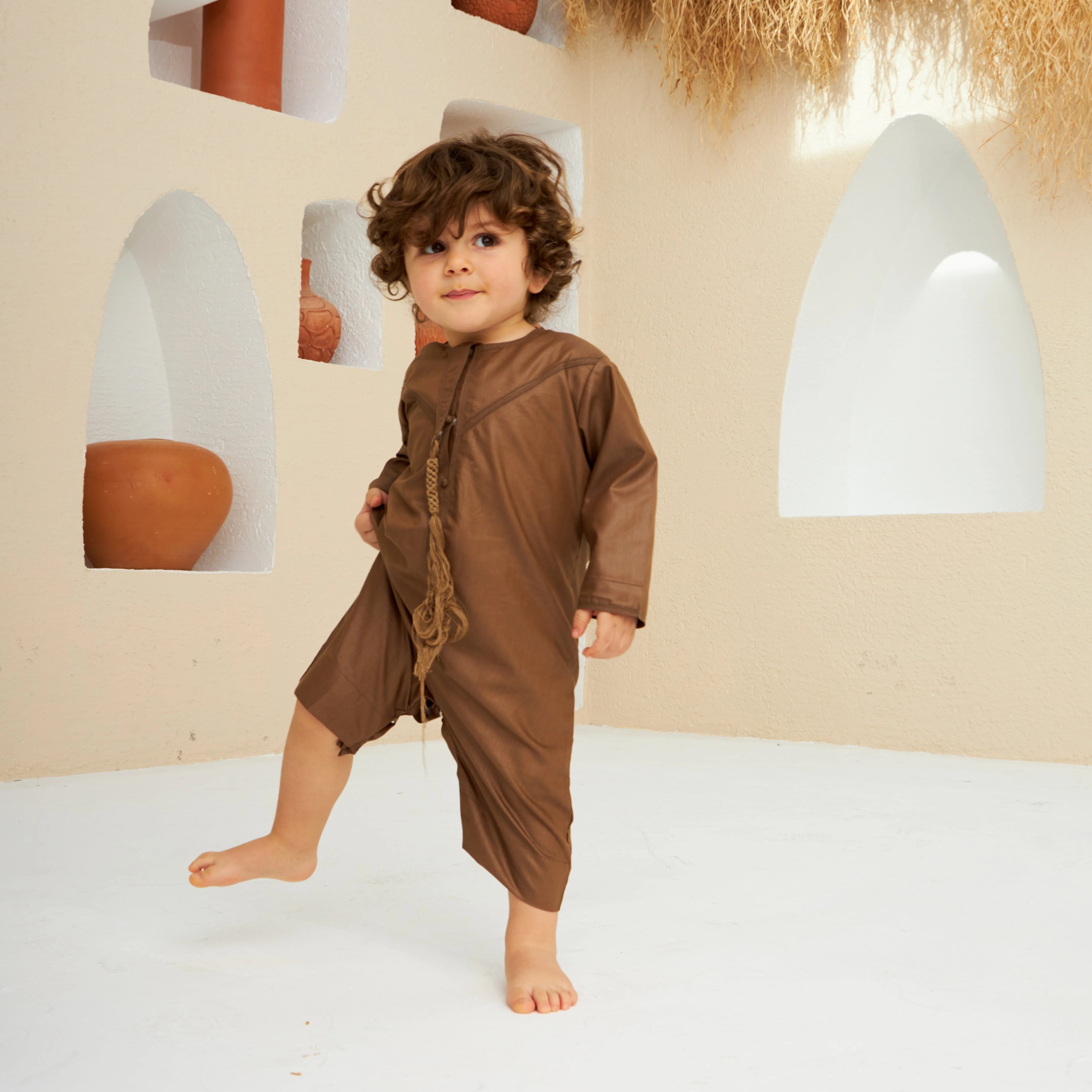 Brown Thobe Romper Boys - Baby Boys Thobe Romper in soft cotton blend with Omani-style tassels, perfect for Ramadan or Eid celebrations. Main image