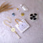 Barakah Hajj Gift Hamper Pack with tasbih, Zamzam water, Ajwa dates, and Islamic accessories on white fur background. Ideal Hajj return gift set.