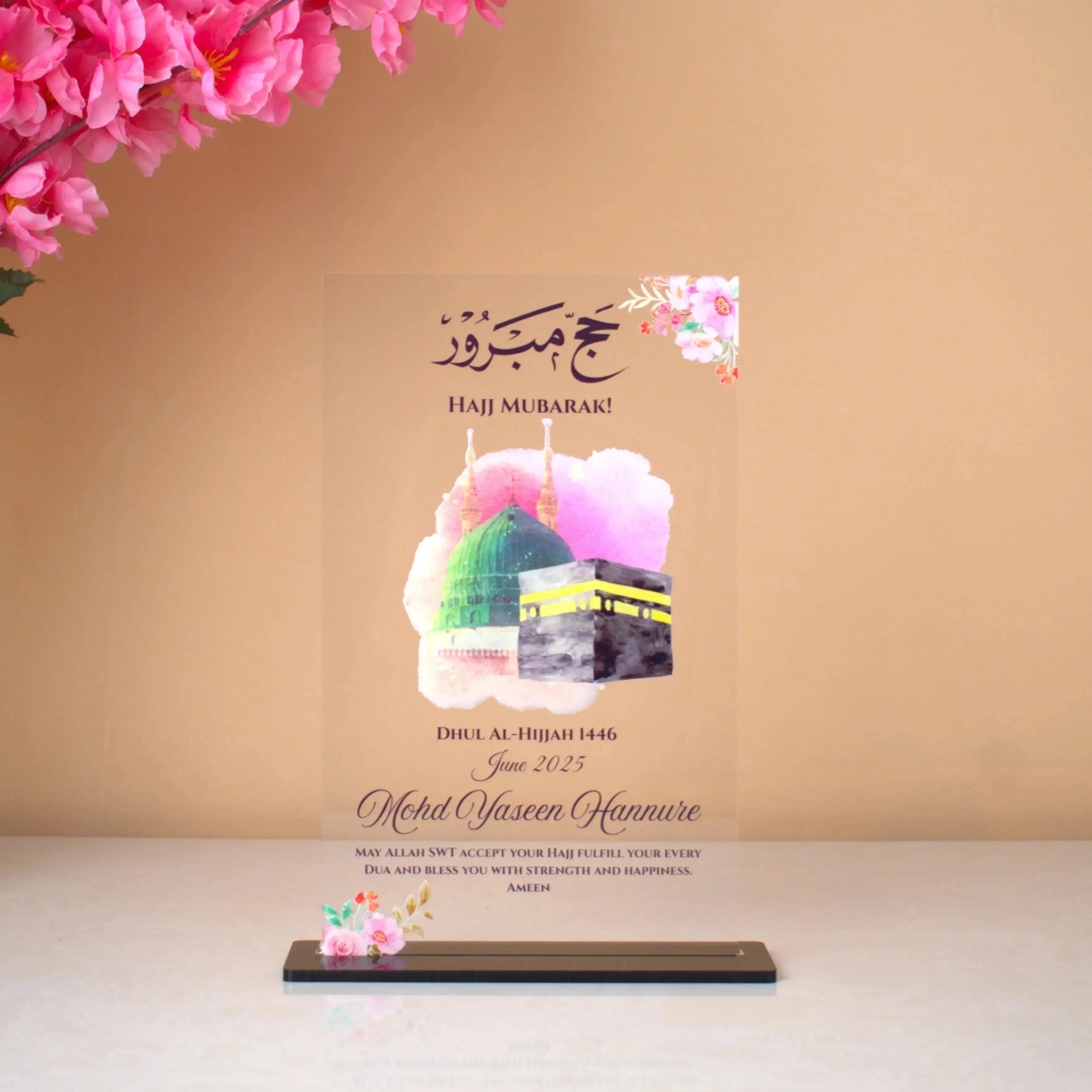 Premium acrylic Hajj Divine View Gifting Plaque with Kaaba and Masjid illustration, floral accents, and personalized text for Hajj 2025. Main image