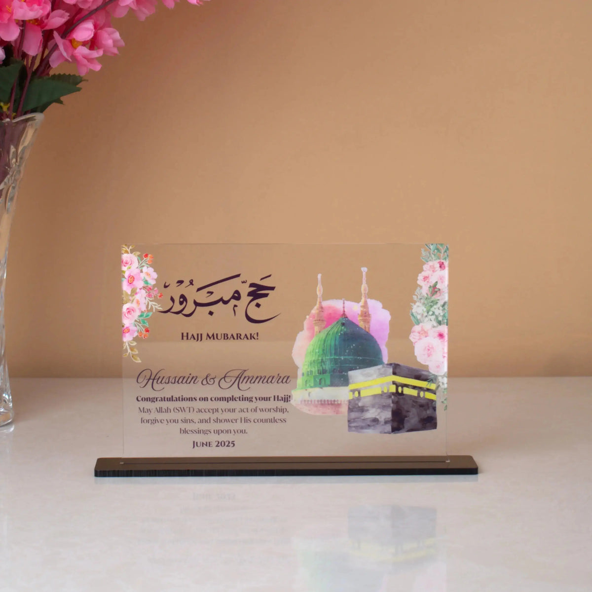 Kaaba Design Plaque in premium acrylic featuring Hajj Mubarak message, floral border, and custom names for Hajj & Umrah gifting.