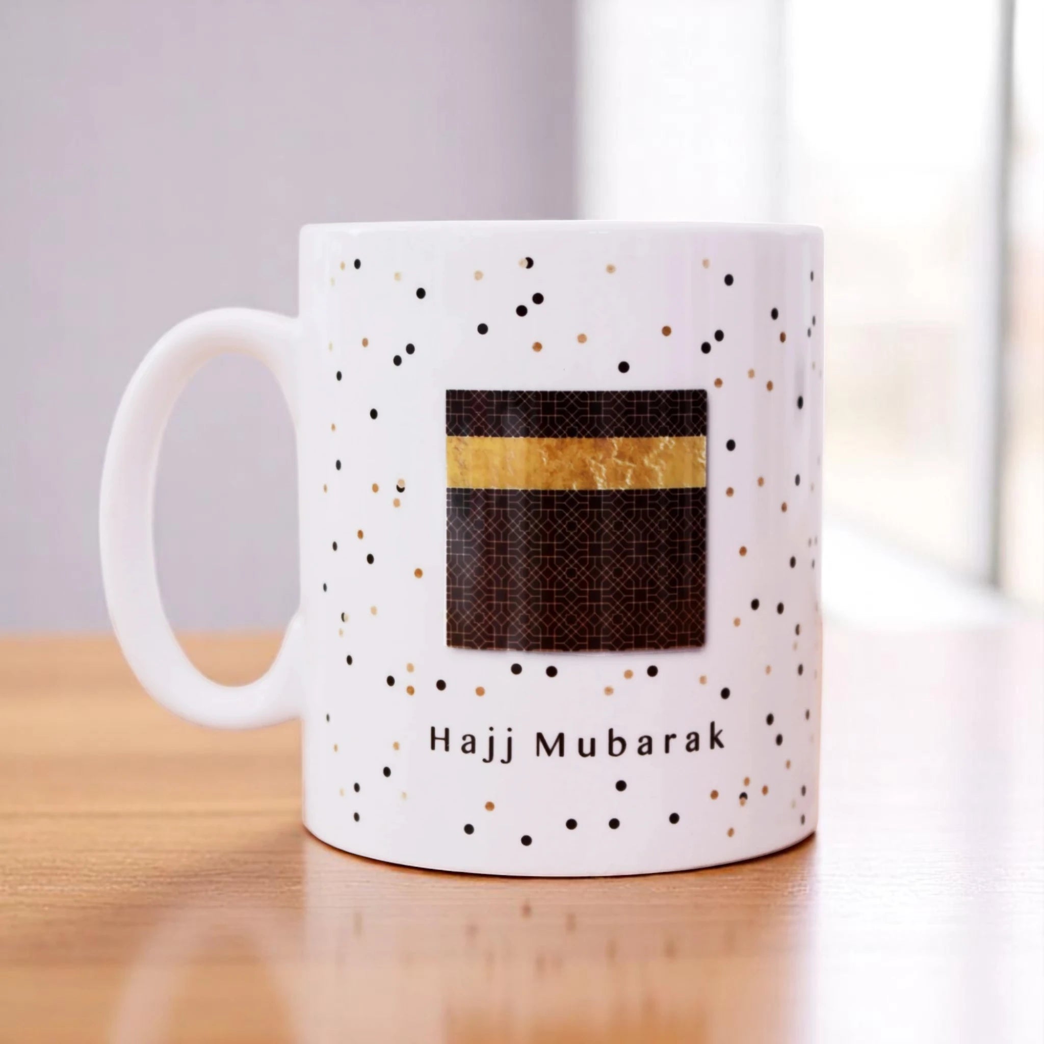 Hajj Mubarak Mug with Kaaba design and gold-black confetti pattern, ideal personalized gift for Hajj returnees or Islamic celebrations. Main image