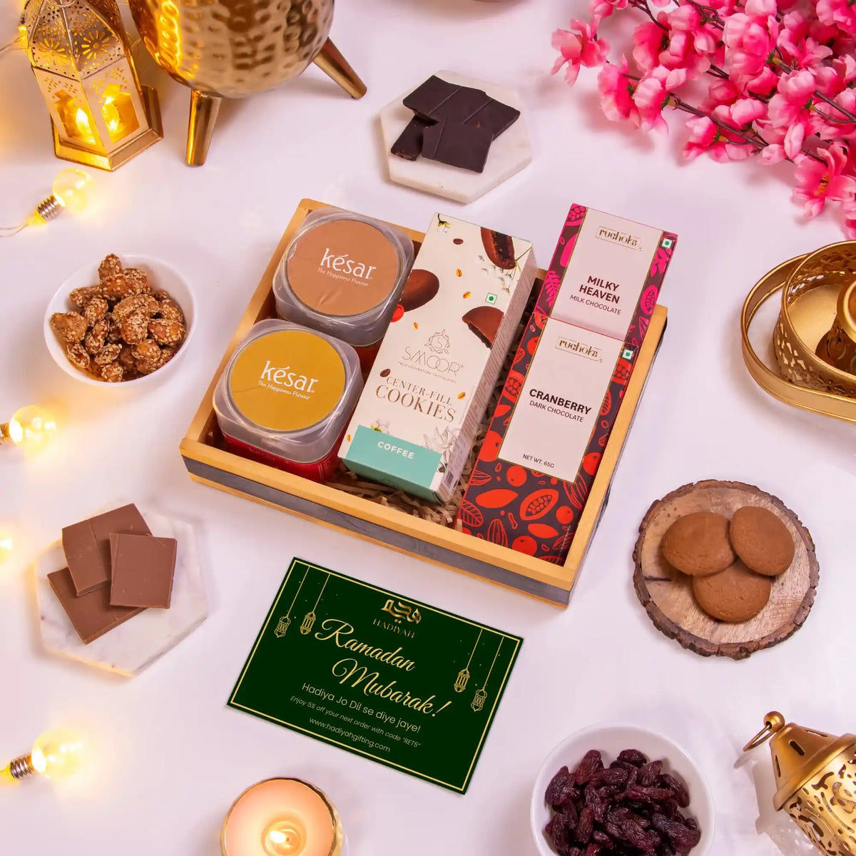Assorted food items and packaging on a white surface with decorative elements.