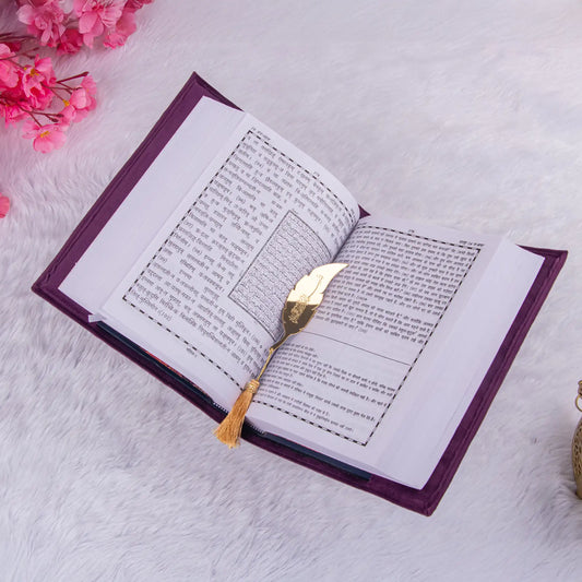 Open Quran with Hindi translation and gold feather bookmark. A thoughtful addition to the Purple Sequence Rehal Hamper for Hindi speakers.