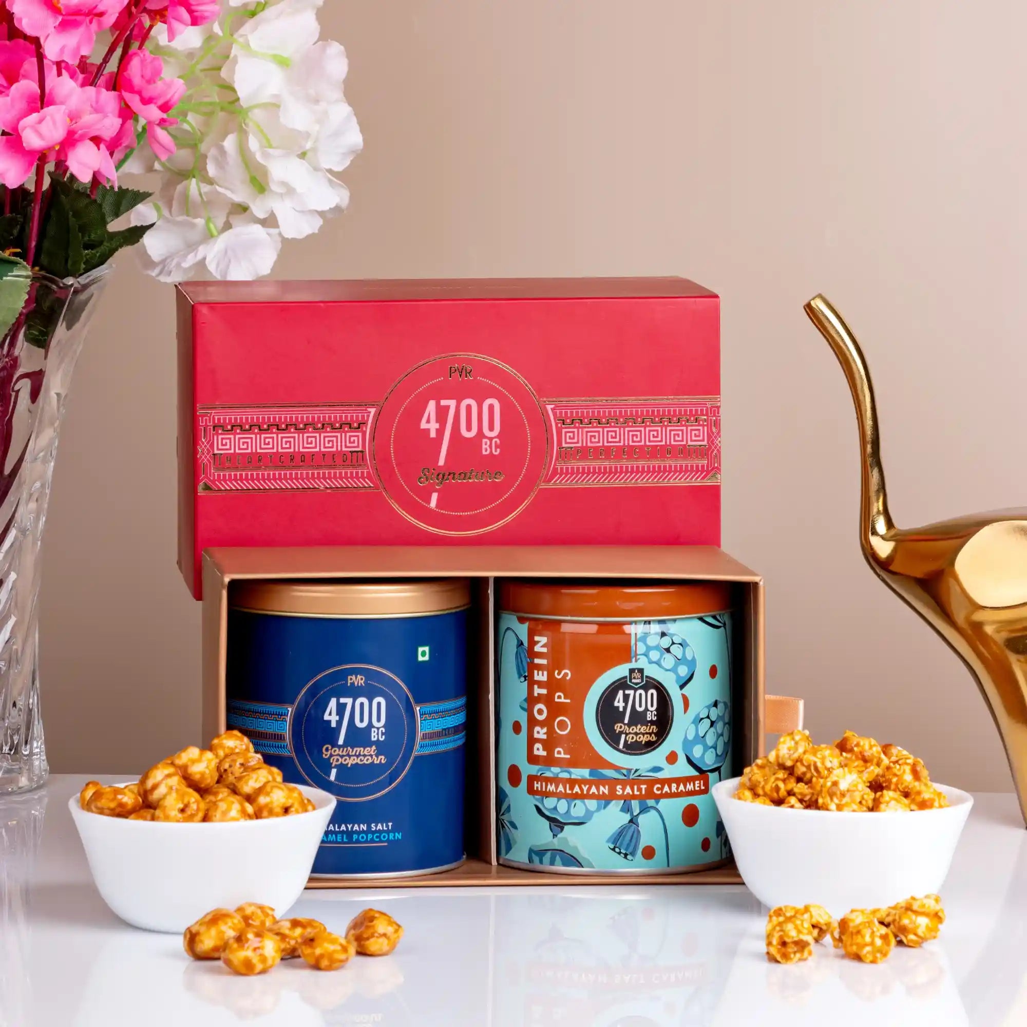 Himalayan Caramel Gourmet Popcorn gift box with two tins of sweet and savory popcorn, ideal for Eid, weddings, and festive gifting traditions. Main image