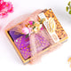 Gift set with purple box, pink fabric, and almond cookies on a white background