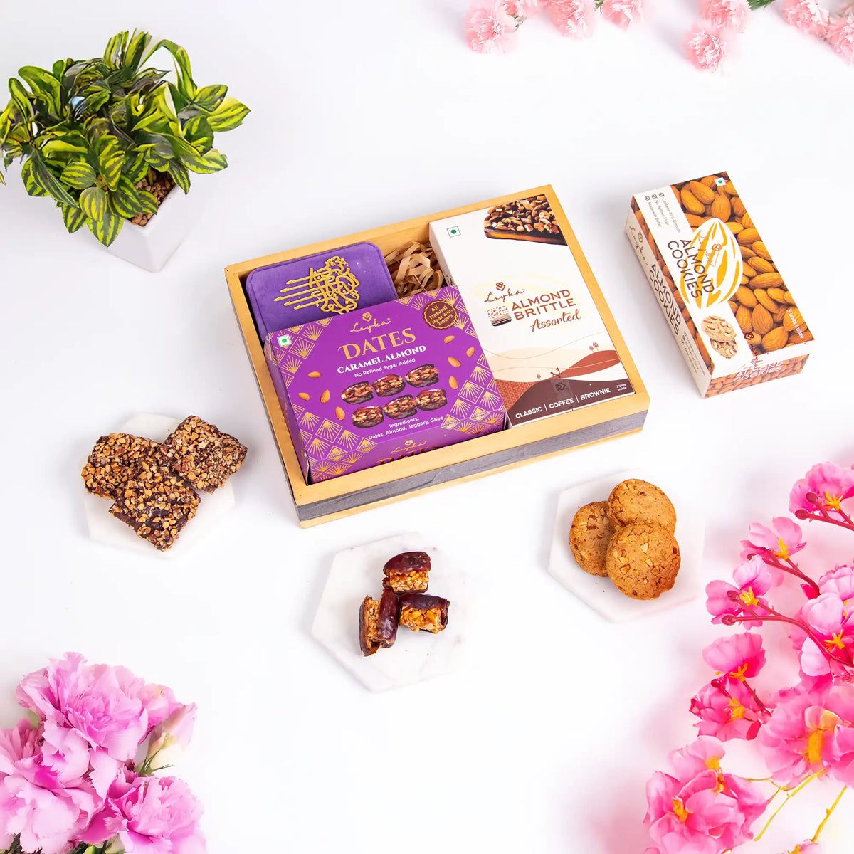 Velvet Serenity & Almond Hamper with almond brittle, caramel dates, and cookies in a wooden tray. Gourmet gift for Ramadan or Dawaat-e-Khaas occasions.