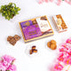 Velvet Serenity & Almond Hamper with almond brittle, caramel dates, and cookies in a wooden tray. Gourmet gift for Ramadan or Dawaat-e-Khaas occasions.