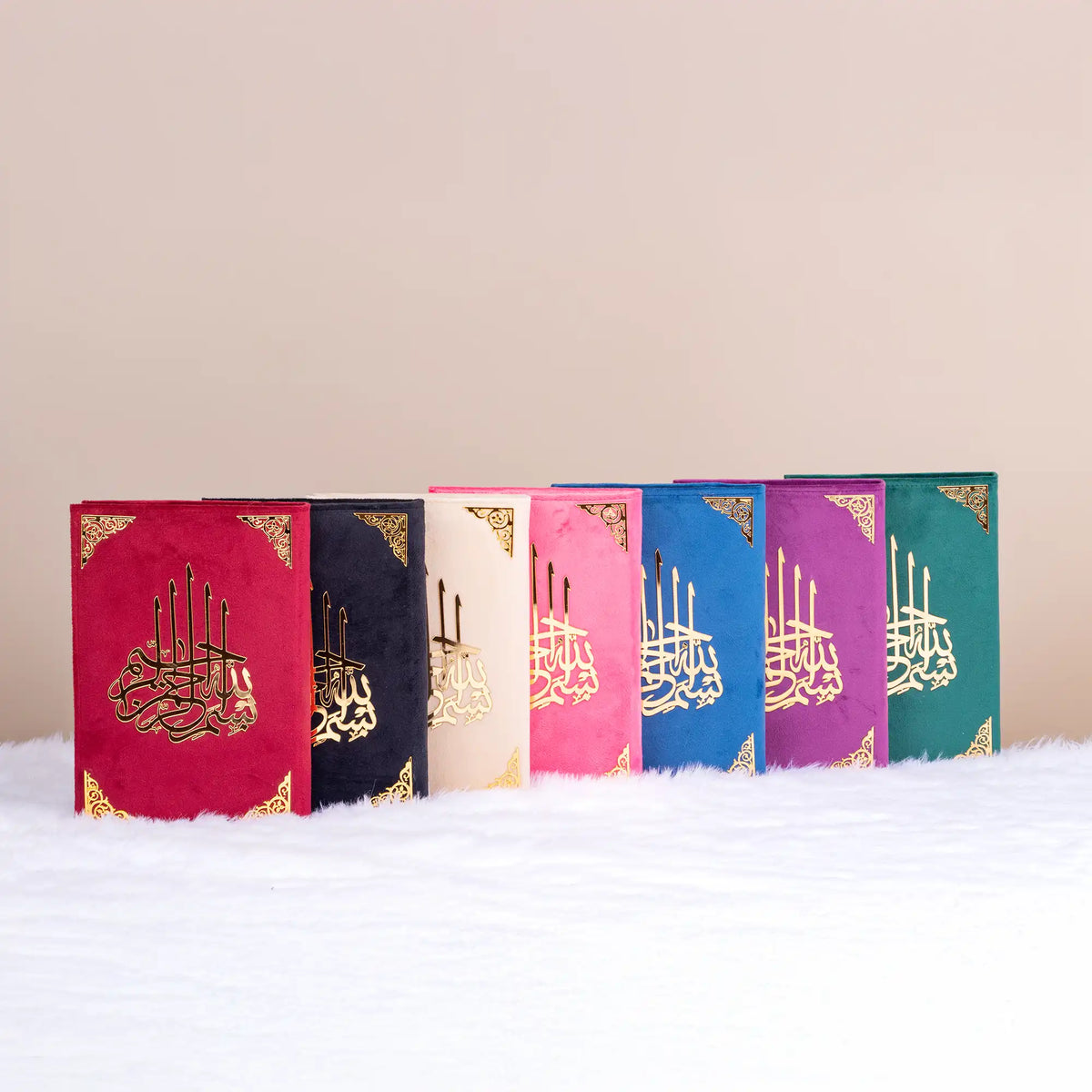Collection of Velvet Covered Qurans in assorted colors with gold Arabic calligraphy. Premium Islamic gift set for religious ceremonies.