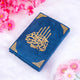 Blue towel with gold calligraphy and floral decorations on a white background