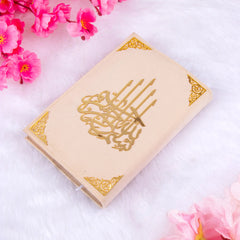 Close-up of offwhite Quran with golden calligraphy cover from the Sawab-E-Jariya Hamper, perfect for religious and ceremonial gifting.