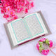 Translation Quran Velvet Cover - Premium Gift in elegant pink setup with floral decor. Ideal for weddings, prayer, or gifting in multiple languages.