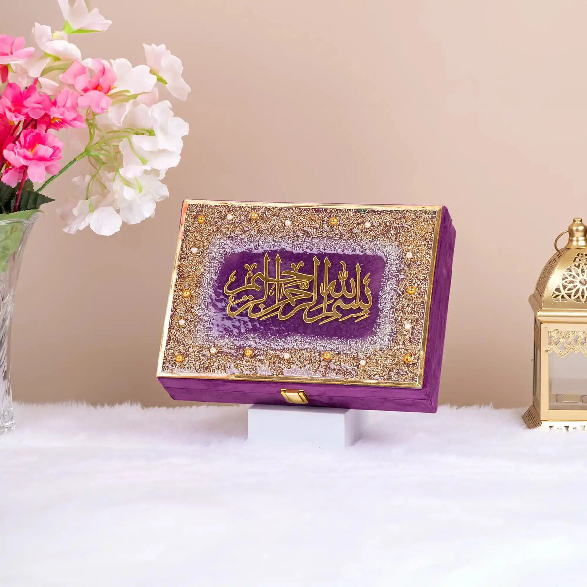 Purple and gold embellished Quran gift box with Arabic calligraphy. Premium packaging from the Purple Sequence Rehal Hamper collection.