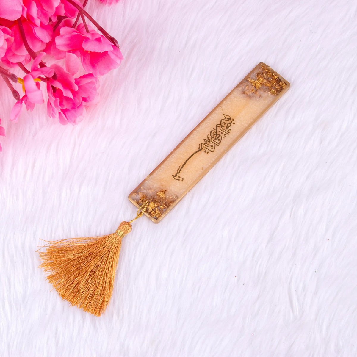 Golden resin Islamic bookmark with tassel from the Golden Floral Pearl Rehal Hamper. Perfect accessory for Quran reading and gifting.