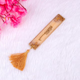 Golden resin Islamic bookmark with tassel from the Golden Floral Pearl Rehal Hamper. Perfect accessory for Quran reading and gifting.