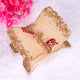 Decorative leaf-shaped plate with gold and beige finish, featuring red flowers, on a white background.
