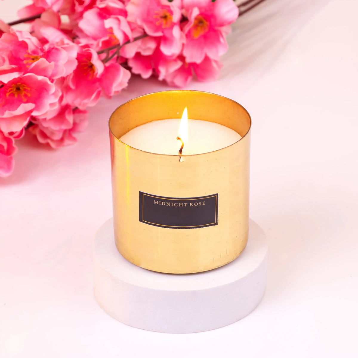Midnight Rose scented candle in a golden holder, part of the Noor Al-Nazakat Sweet Treats Hamper. Adds elegance and aroma to premium gift hampers.