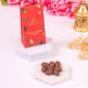 Close-up of Smoor Choco-Coated Almonds from Khushi Aur Mithaas Ka Tohfa hamper. Premium sweet treat for festive and gourmet gift baskets.