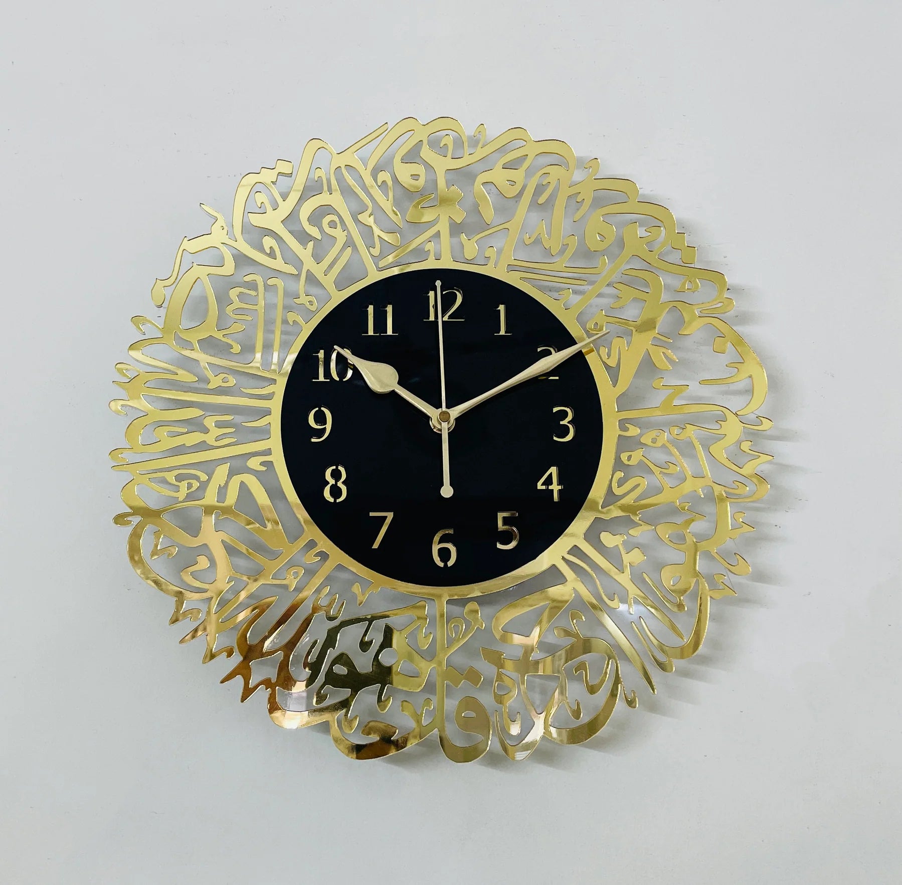 Surah Al Ikhlas Wall Clock with gold Arabic calligraphy on black face, blending timeless elegance and spiritual design for home decor. Main image