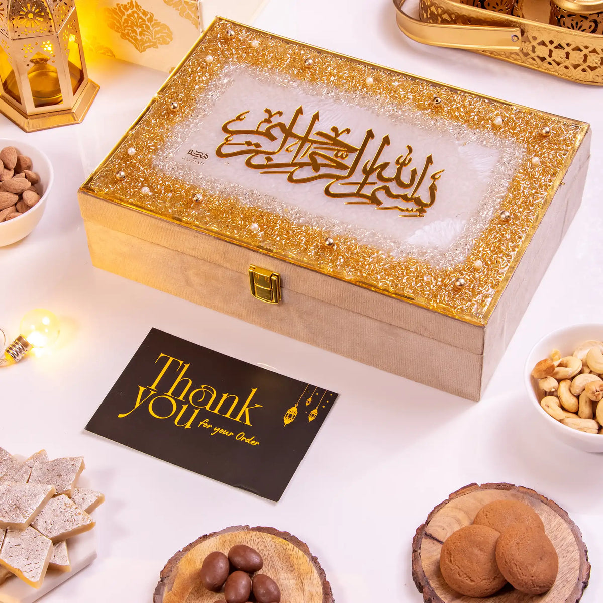 Elegant Noor Al-Lazeez Sweet Collection gift box with golden Arabic calligraphy, perfect for festive gifting with sweets and dry fruits.