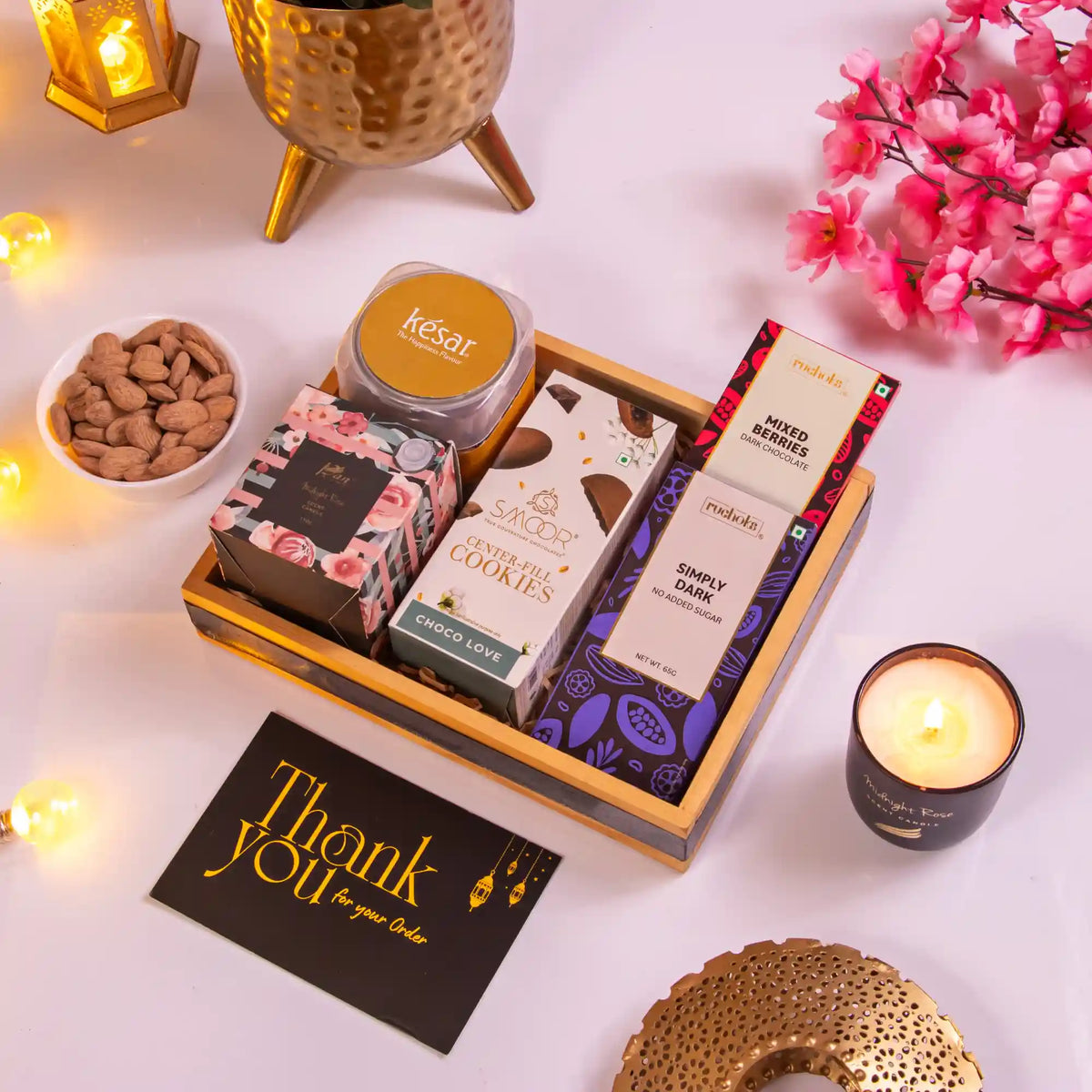 Sweets Serenity Hamper featuring Noor Al-Sweets with gourmet chocolates, cookies, almonds, candle, and thank you card for Ramadan gifting.