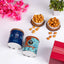 Noor Al-Sweets & Serenity Hamper with chocolates, cookies, almonds, candle, and greeting card in a wooden tray. Ideal Ramadan gift hamper.