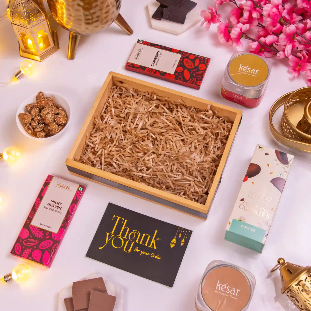 Empty wooden gift box with shredded filler from the Heavenly Indulgence Treat Hamper, ready for Ramadan and Eid packaging.