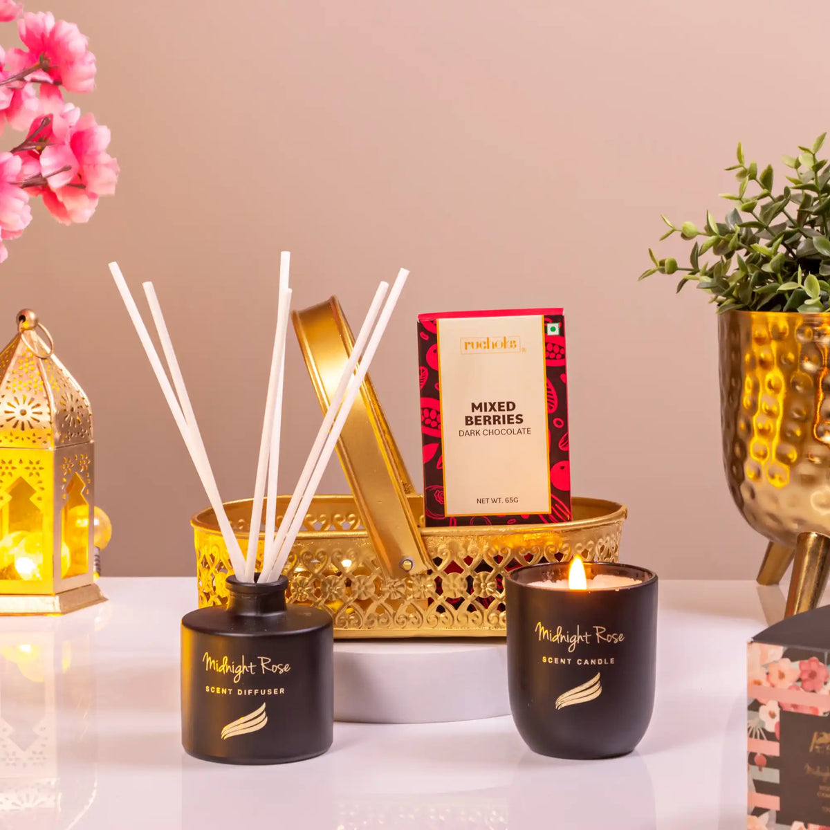 Elegant Ramadan Gift Hamper with Midnight Rose candle, diffuser, and mixed berries dark chocolate in a decorative golden basket.