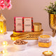 Noor Al-Nazakat Sweet Treats Hamper featuring Milky Heaven and Cranberry chocolates, roasted almonds, and kesar sweets in a decorative golden tray.