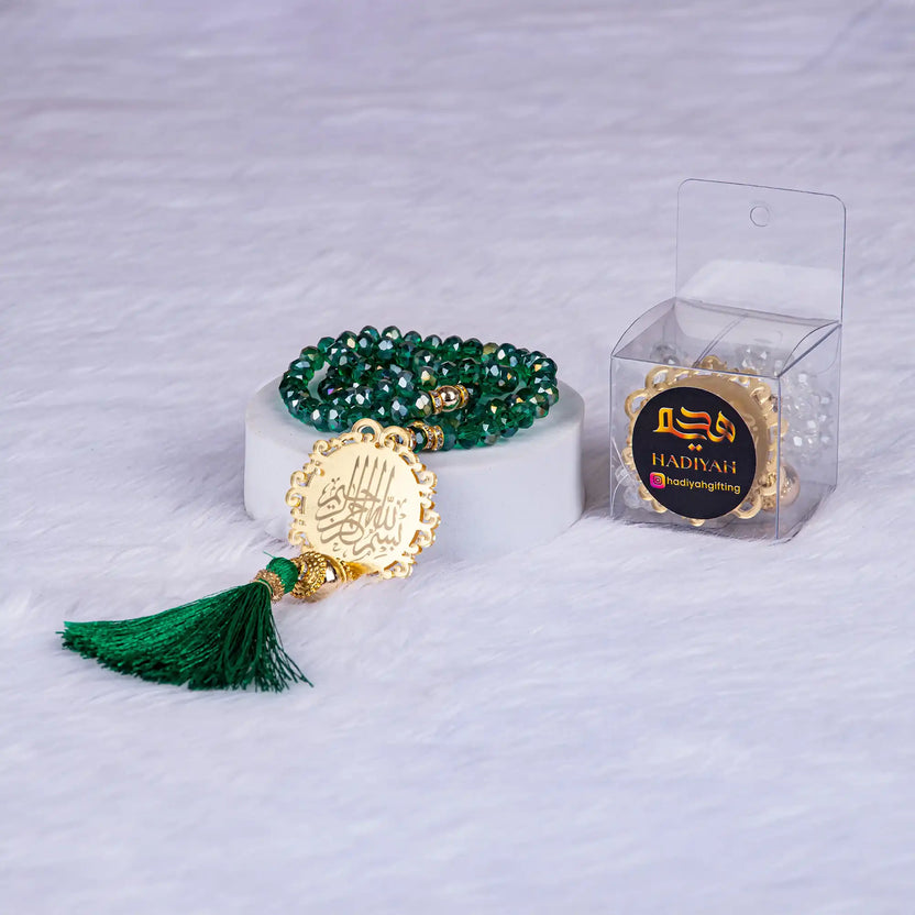 Elegant 100 Beads Green Crystal Tasbeeh featuring gold Bismillah medallion, perfect for Hajj, Umrah, or bridal gifting. Main image