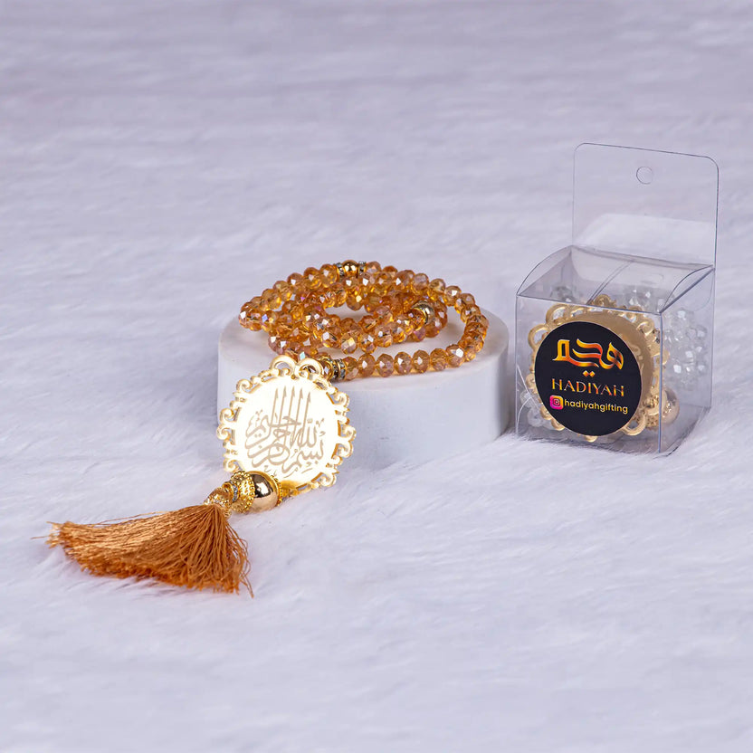 Golden tasbeeh with crystal beads and Arabic medallion, elegantly packed in a Hadiyah branded box from the Bling Collection. Main image