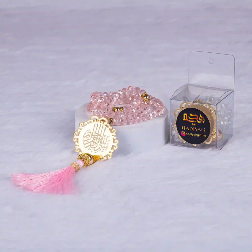 Pink Crystal Tasbeeh with Bismillah charm and tassel, elegantly packed for gifting; perfect for Hajj, Umrah, or wedding celebrations. Main image