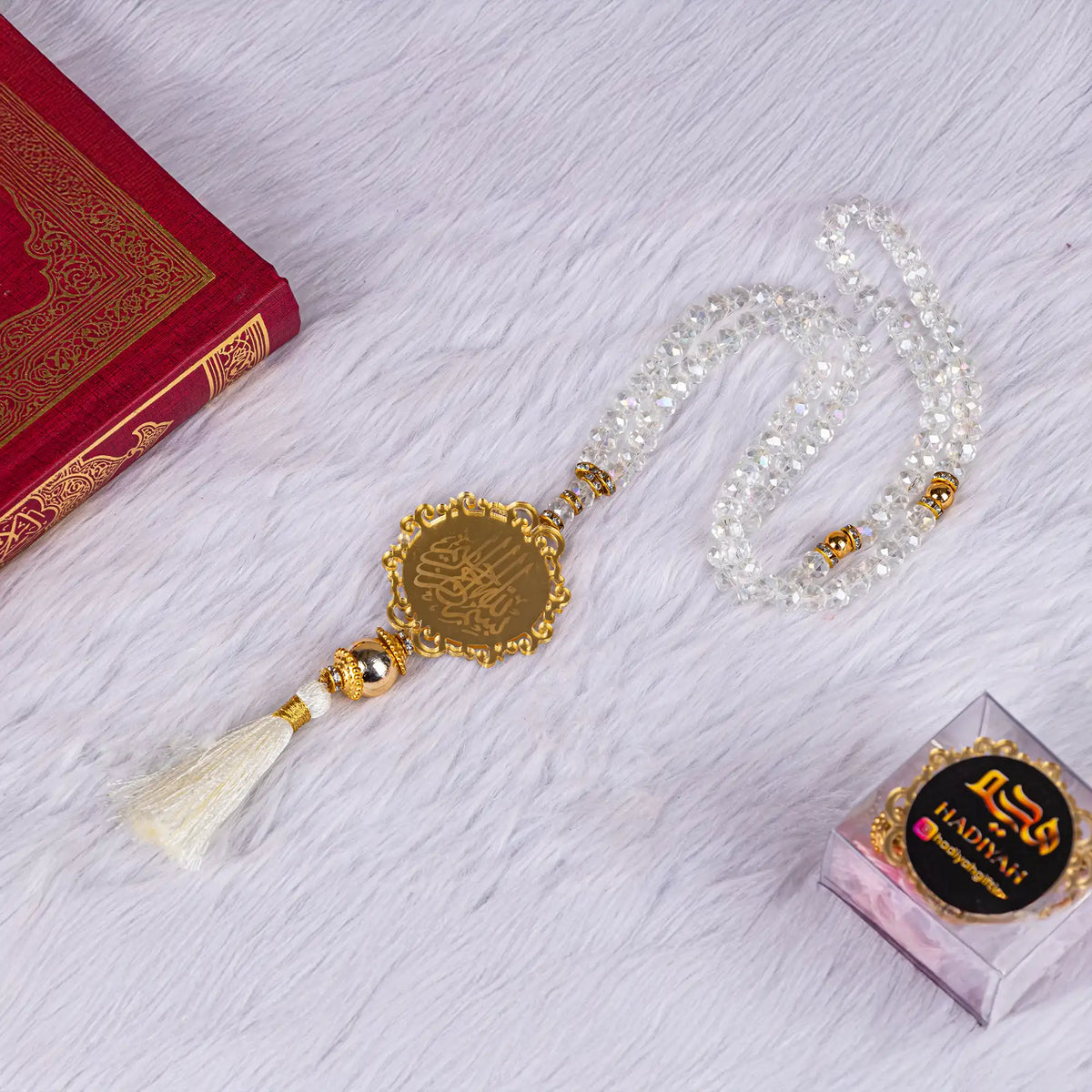 Crystal tasbeeh with gold Arabic calligraphy pendant, included in the Amaanat-e-Nikaah premium Quran gift set.
