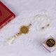 Offwhite Rehal Hamper with decorative Quran, crystal Tasbeeh, and gold Islamic medallion. Elegant Quran gift set for religious occasions.