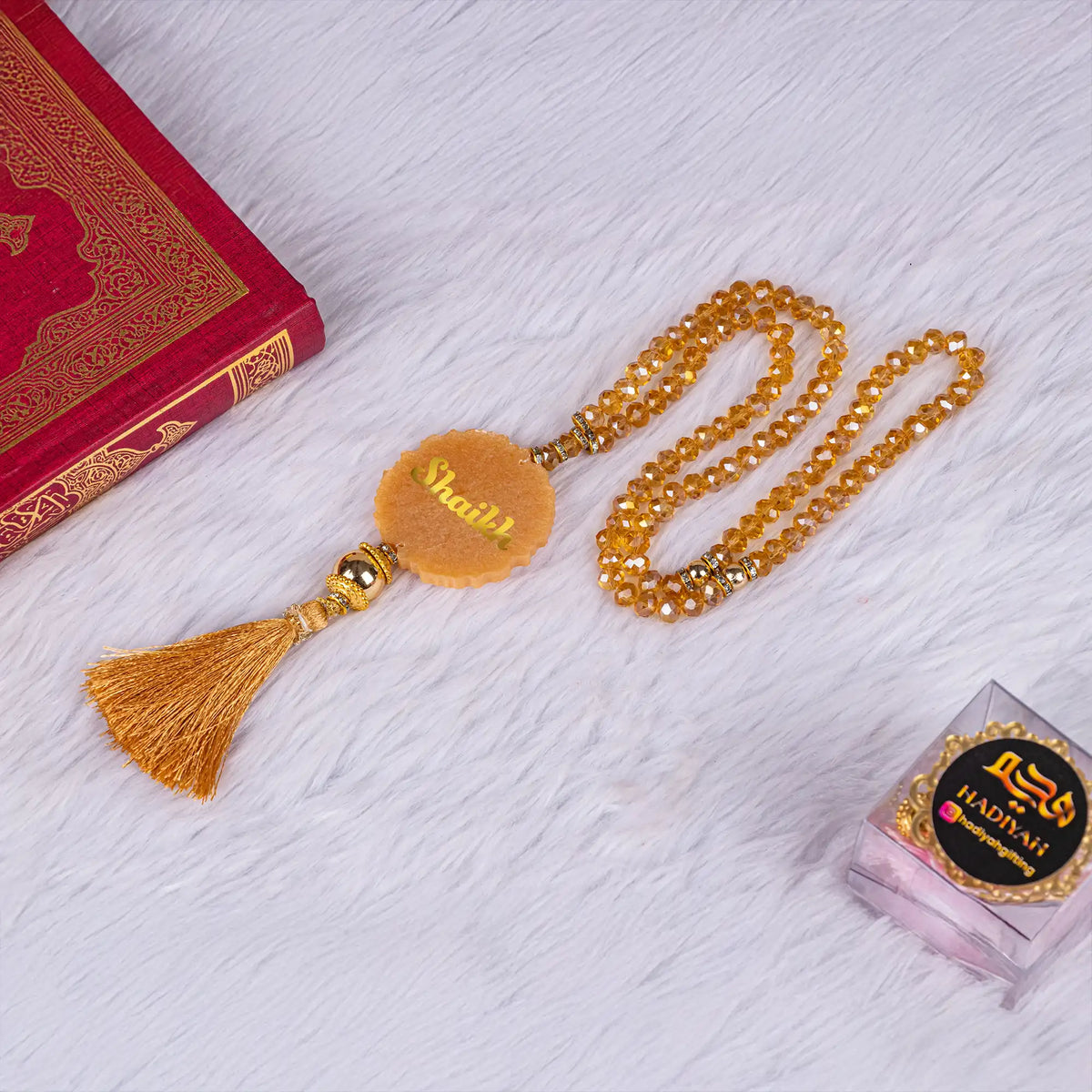 Golden tasbeeh with personalized 'Shaikh' charm and tassel, ideal for gifting in the Sawab-e-Jariya Quran Gift Set.