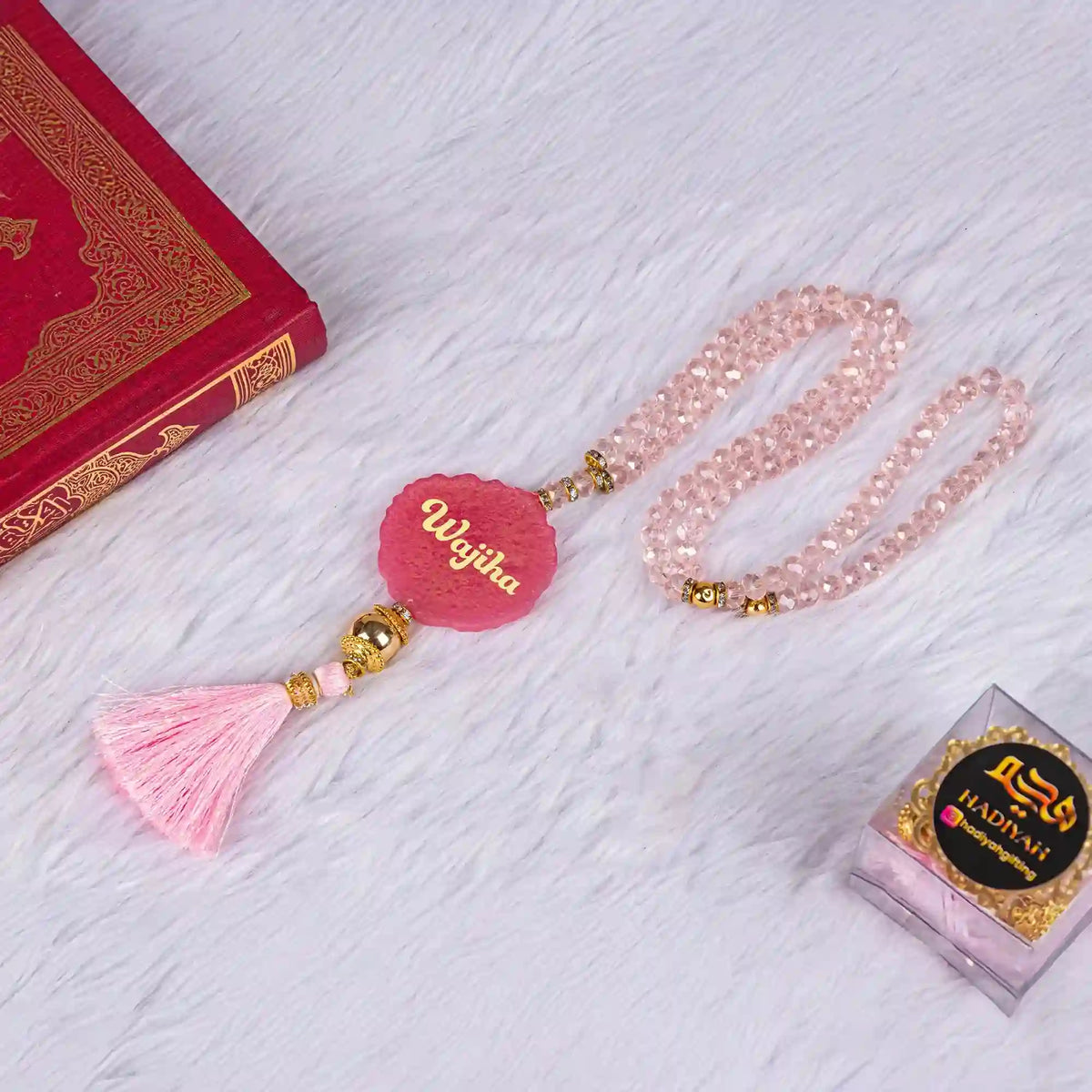 Pink Sequence Sawab-e-Jariya Quran gift set featuring a personalized crystal Tasbeeh with name 'Wajiha', velvet Quran, and Hadiya box on white fur.