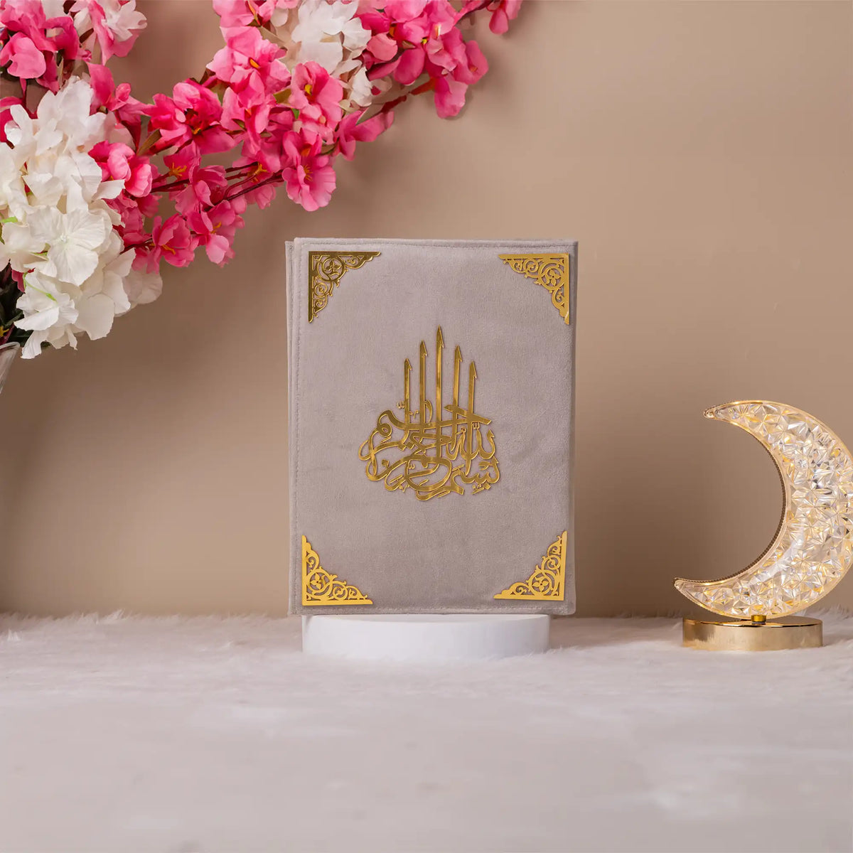 Gray Velvet Quran with gold detailing on display, premium translation Quran for gifting or religious use.