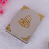 Flat lay of gray Premium Velvet Quran with gold accents, elegant Islamic gift for men or women.