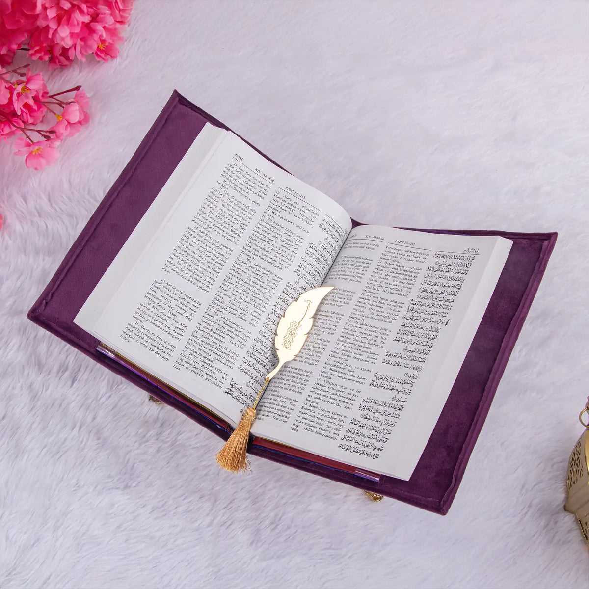 Open velvet Quran with Urdu translation and gold feather bookmark from the Bridal Purple Rehal Hamper, ideal for religious gifting.