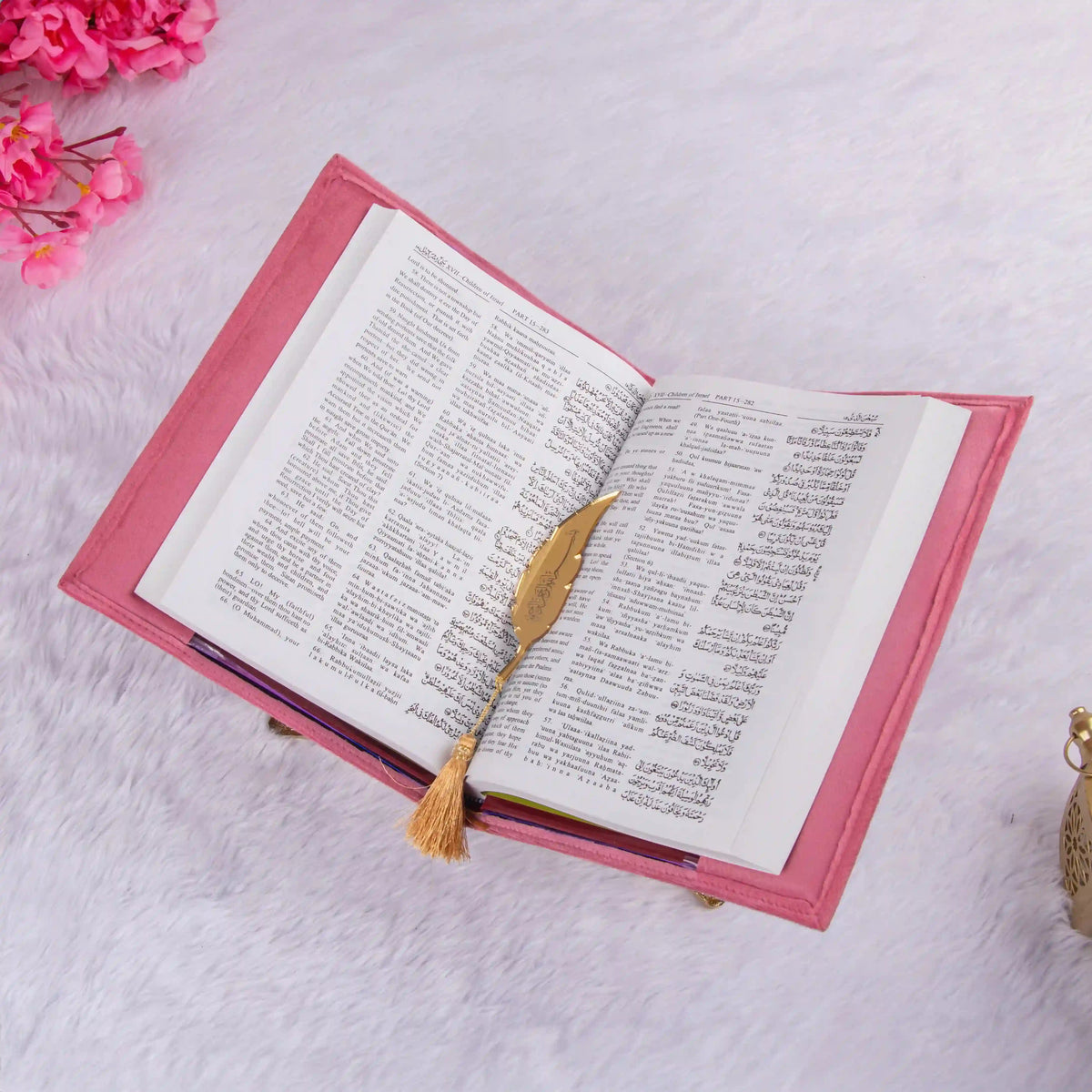 Open pink velvet Quran from the Butterfly Quran Gift Set with dual-language text and a gold feather bookmark, ideal Sawab-e-Jariya gift.