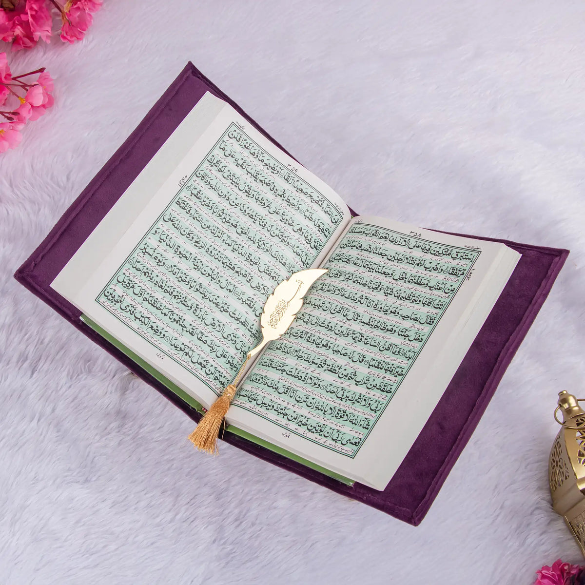 Open Velvet Quran Translation in purple with Arabic script and gold feather bookmark, perfect for daily recitation or gifting.