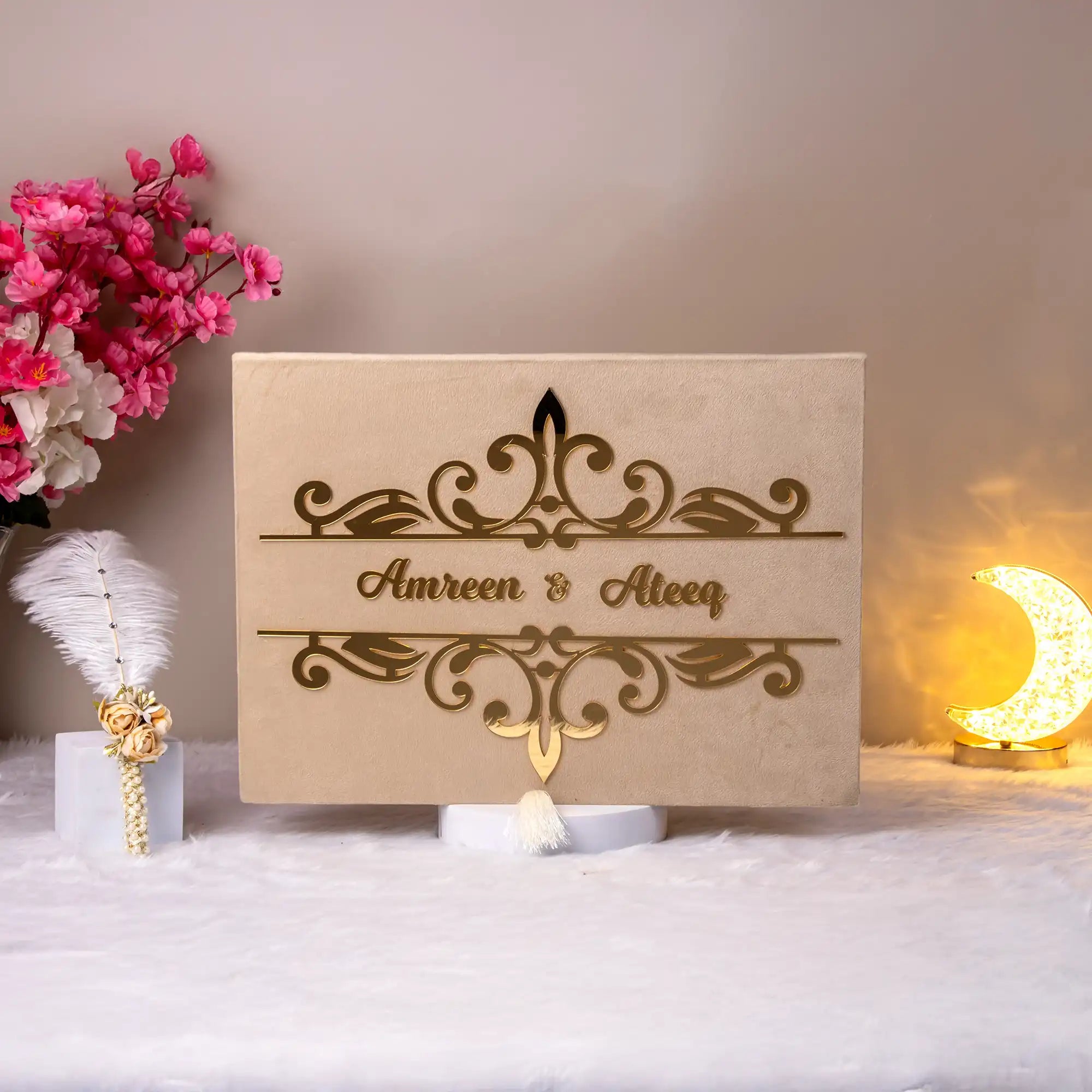 Closed beige velvet Nikah Nama Hamper box with gold foil couple's names, part of the Divine Elegance wedding collection.