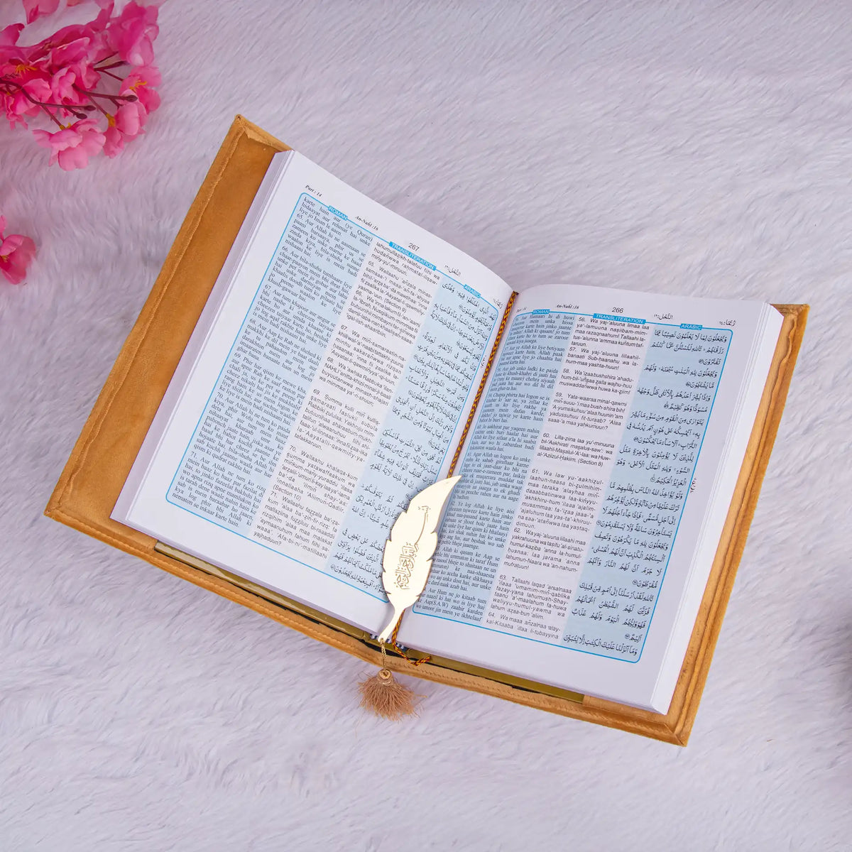 Golden Quran with blue and white translation pages and gold tassel bookmark, from the Golden Sawab-e-Jariya Bling Quran Gift Set.